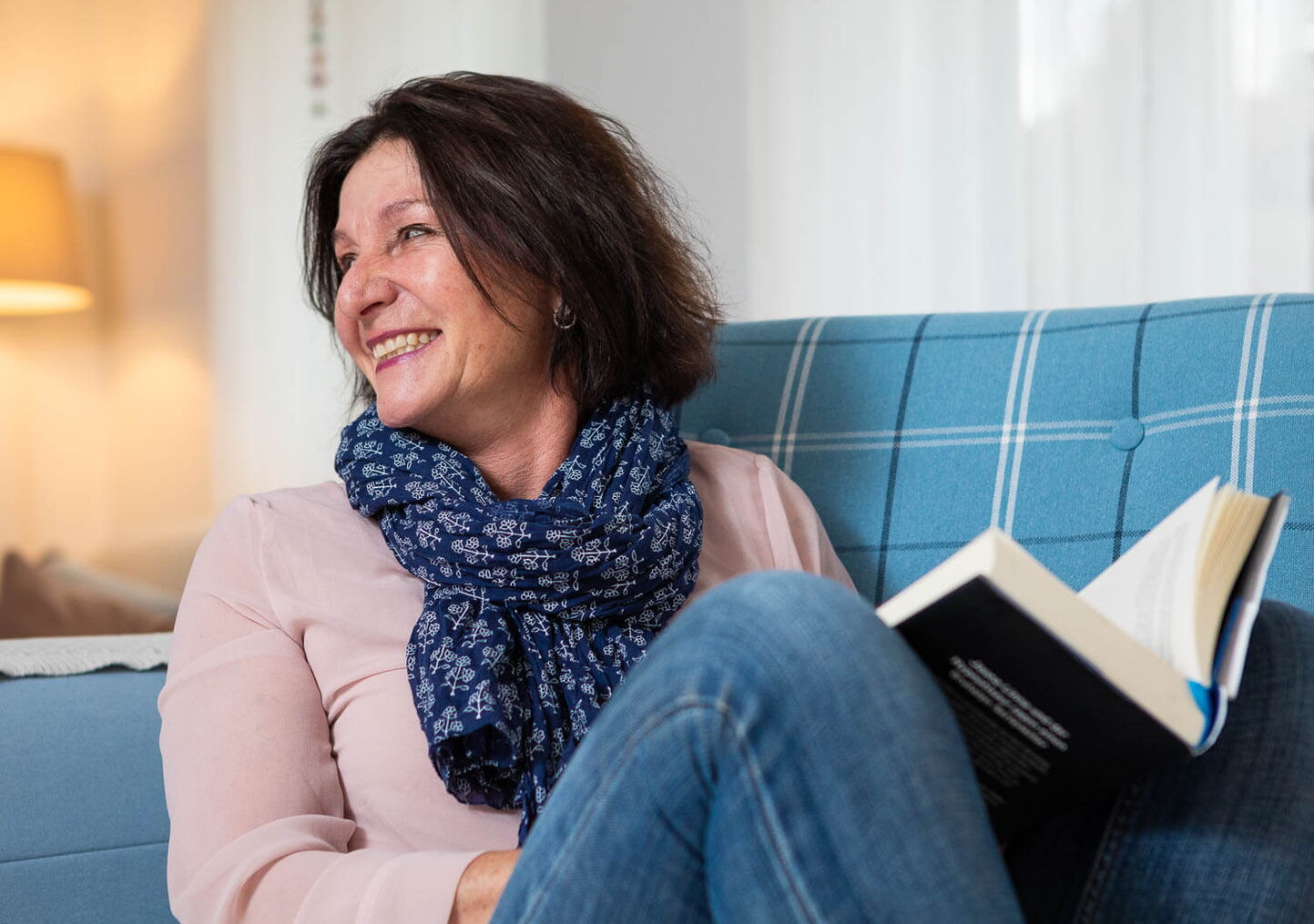 portraitfotograf luzern: Foto einer Frau in blauem Sessel mit Buch